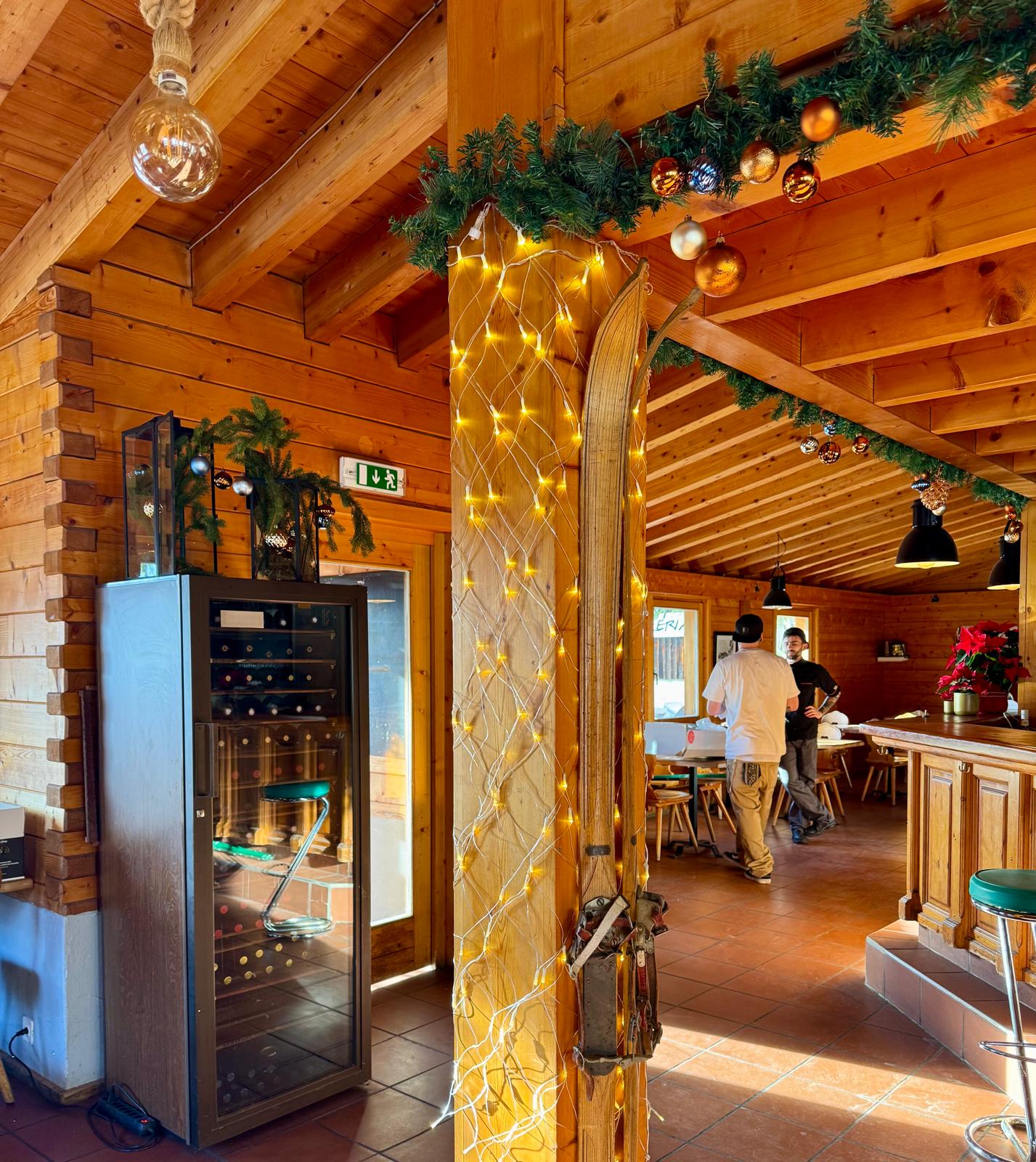 Restaurant decorated with fir branches and red baubles